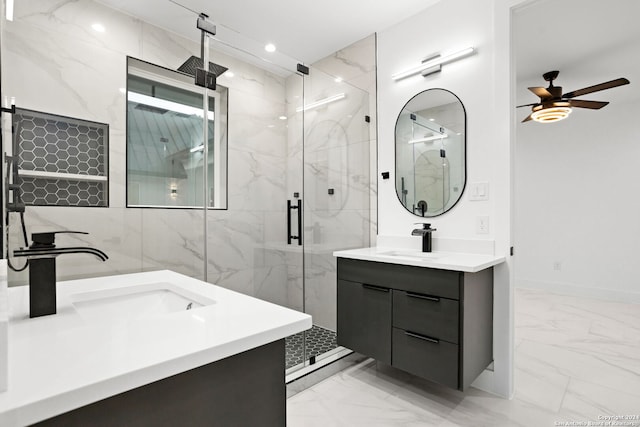 bathroom with ceiling fan, walk in shower, and vanity