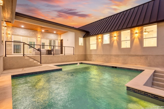 view of pool at dusk