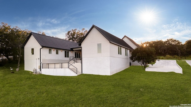 rear view of property featuring a patio and a yard