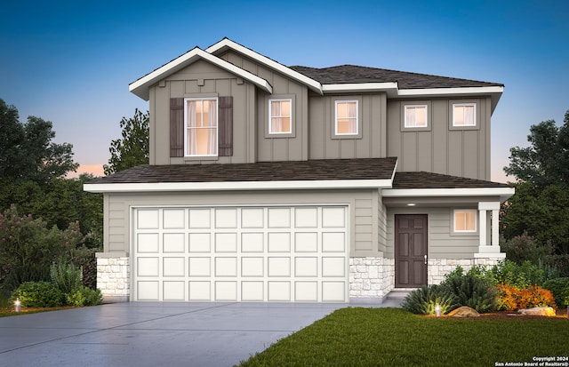 view of front of home with a garage and a lawn