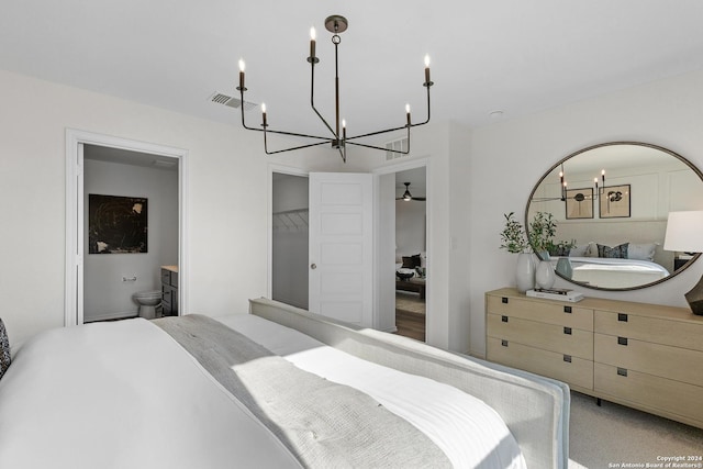 carpeted bedroom featuring ensuite bathroom, visible vents, and a notable chandelier