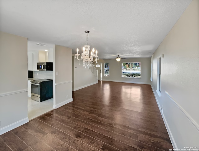 unfurnished dining area featuring a textured ceiling, ceiling fan with notable chandelier, and dark hardwood / wood-style floors