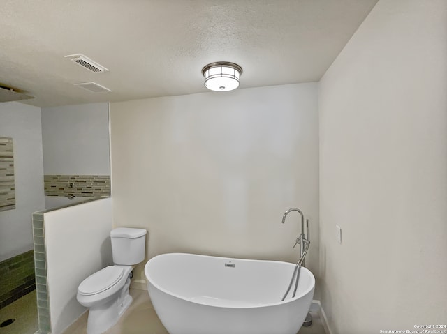 bathroom with independent shower and bath, a textured ceiling, and toilet