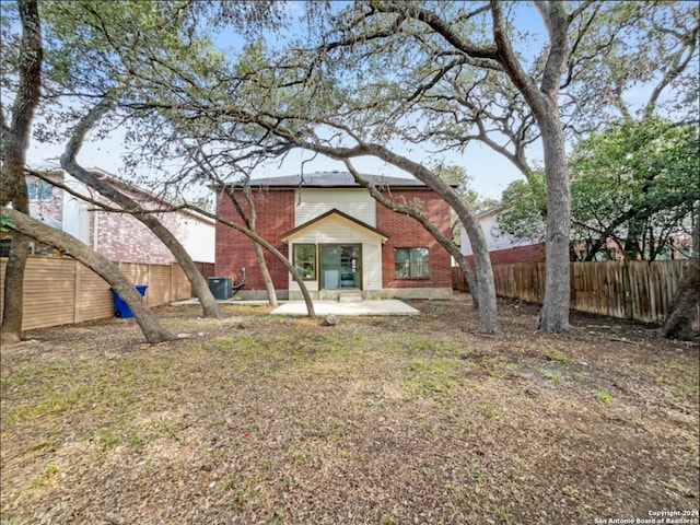 rear view of property featuring a patio area