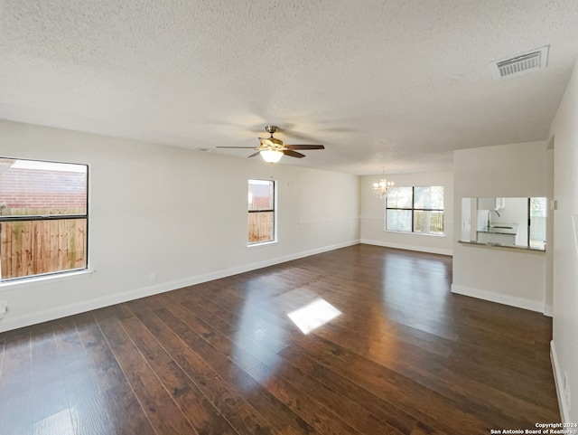 empty room with a textured ceiling and dark hardwood / wood-style floors