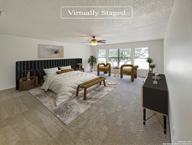 bedroom featuring a textured ceiling, carpet floors, and ceiling fan