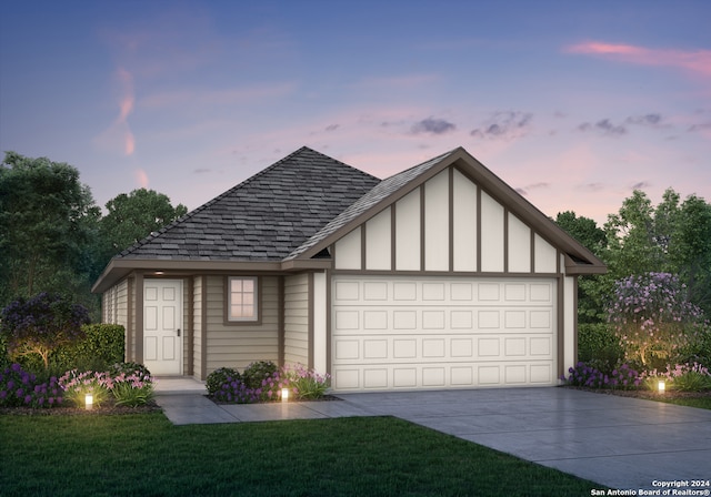 view of front of home featuring a garage and a lawn