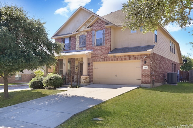 view of front of property featuring a garage, central air condition unit, and a front lawn