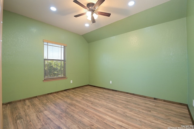 spare room with lofted ceiling, ceiling fan, and hardwood / wood-style flooring