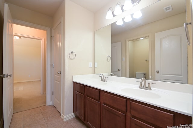 bathroom with vanity, toilet, and tile patterned floors