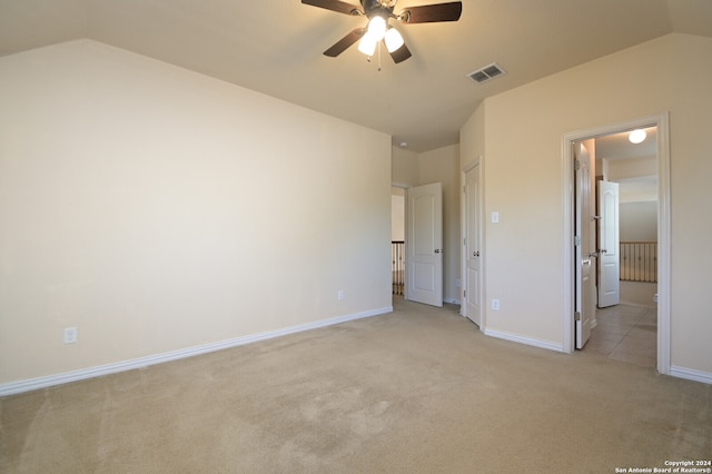 unfurnished bedroom featuring vaulted ceiling, ceiling fan, and light colored carpet