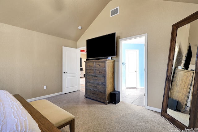 carpeted bedroom with high vaulted ceiling