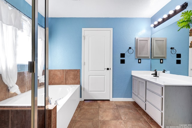 bathroom with independent shower and bath, tile patterned flooring, and vanity