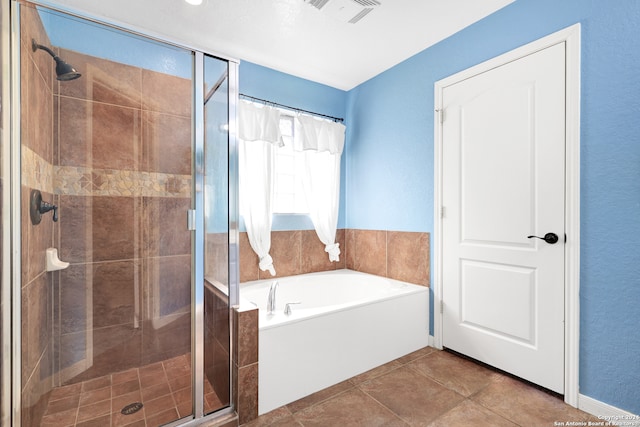 bathroom with separate shower and tub and tile patterned flooring