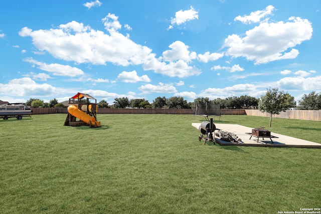 view of yard featuring a playground and a patio area