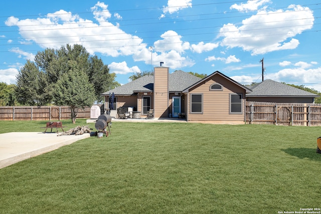 rear view of property featuring a lawn and a patio area