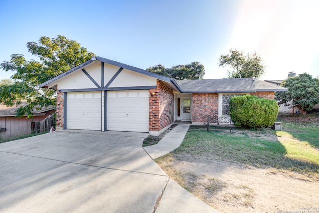 single story home featuring a garage and a front yard