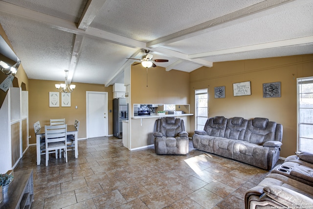 living room with ceiling fan with notable chandelier, a wealth of natural light, a textured ceiling, and lofted ceiling with beams