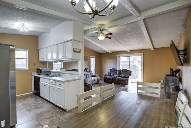 kitchen with lofted ceiling with beams, white cabinets, stainless steel appliances, ceiling fan, and sink