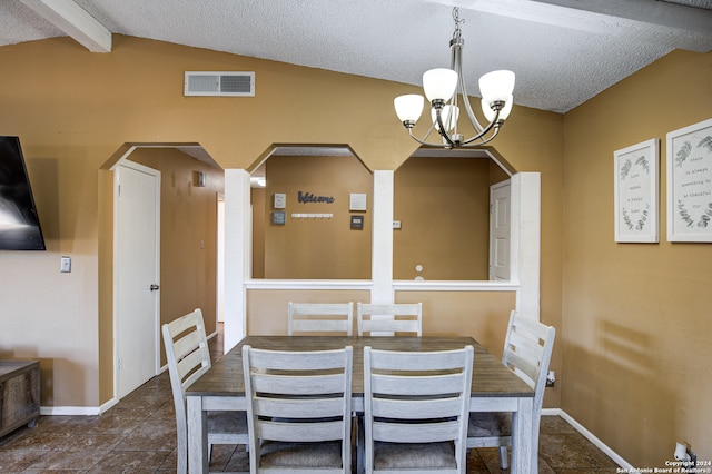 dining room with a textured ceiling, vaulted ceiling with beams, and a chandelier