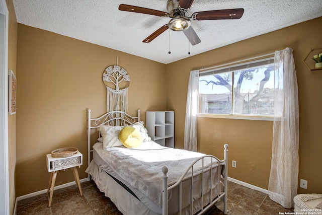 bedroom featuring a textured ceiling and ceiling fan