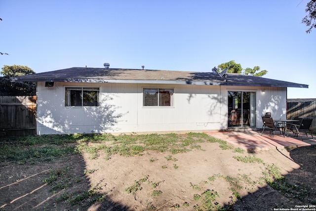 back of property with a patio