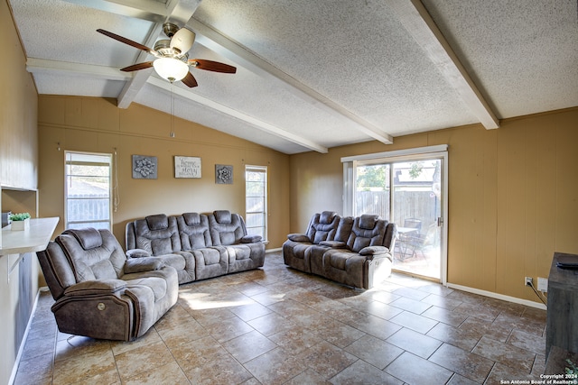 living room featuring a textured ceiling, lofted ceiling with beams, and ceiling fan