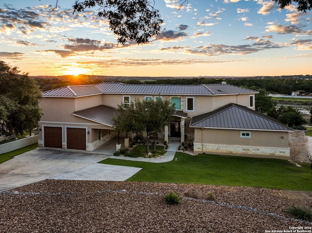 view of front of house with a garage and a yard