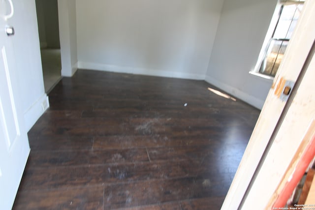 spare room with dark hardwood / wood-style floors