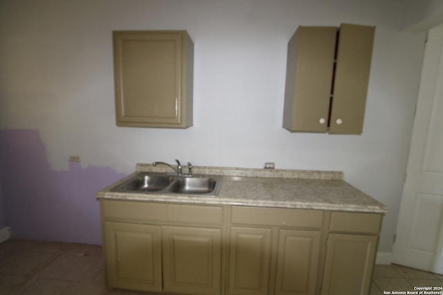 kitchen featuring light tile patterned flooring and sink