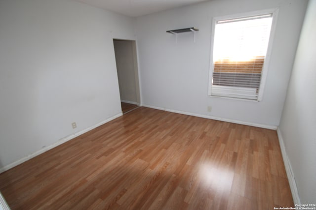 unfurnished room with light wood-type flooring