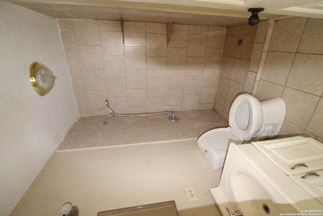 bathroom with washer / dryer and toilet