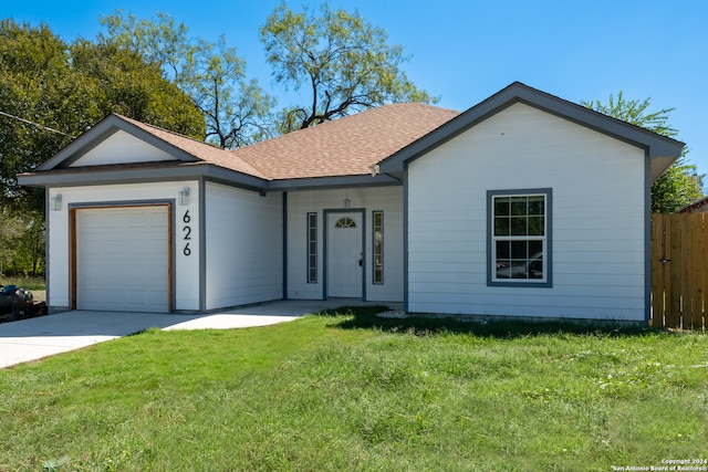 single story home featuring a front lawn and a garage