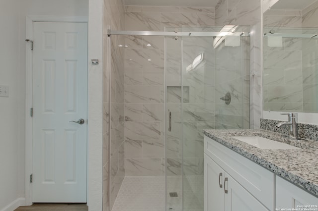 bathroom featuring vanity and an enclosed shower