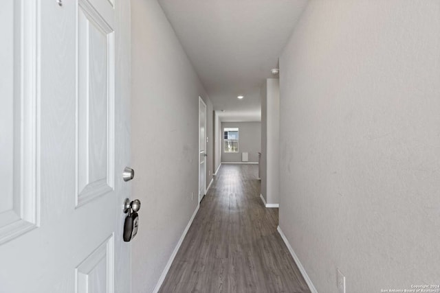 corridor with dark hardwood / wood-style floors