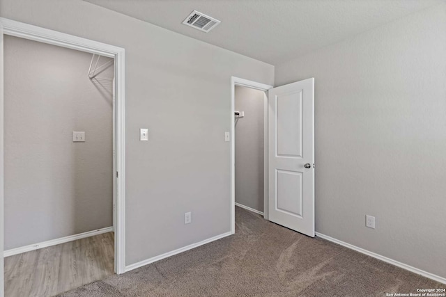 unfurnished bedroom featuring dark colored carpet