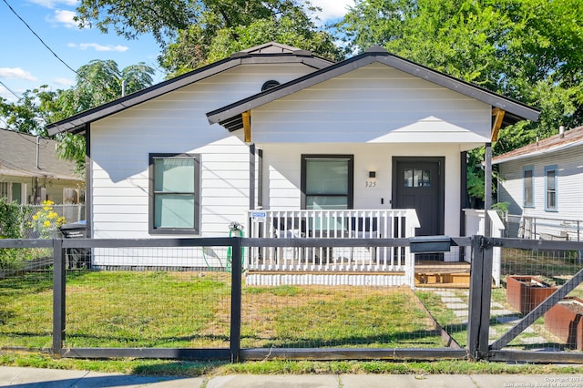 bungalow-style home featuring a front lawn and a porch