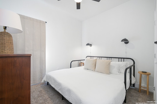 bedroom with ceiling fan, vaulted ceiling, and carpet