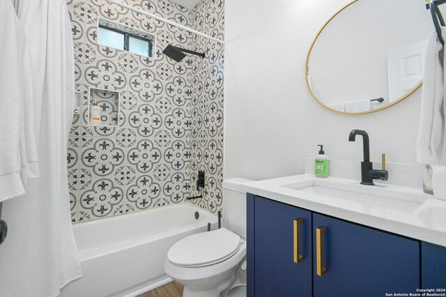 full bathroom featuring shower / bath combination with curtain, vanity, and toilet