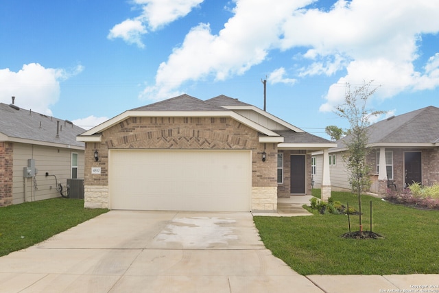 view of front of property featuring a garage, central AC, and a front lawn