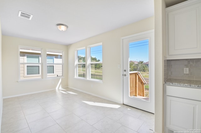 interior space featuring light tile patterned floors