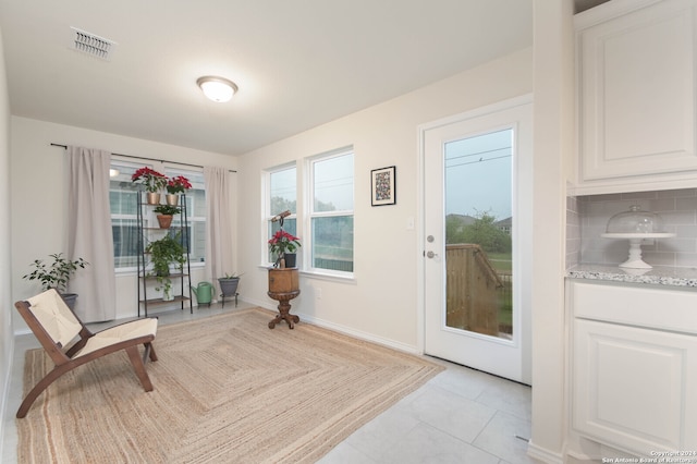 entryway with light tile patterned floors