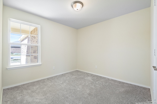 spare room with light colored carpet