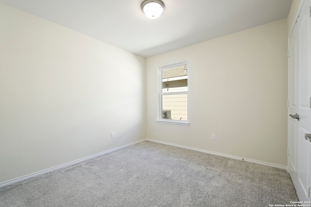 spare room with light colored carpet