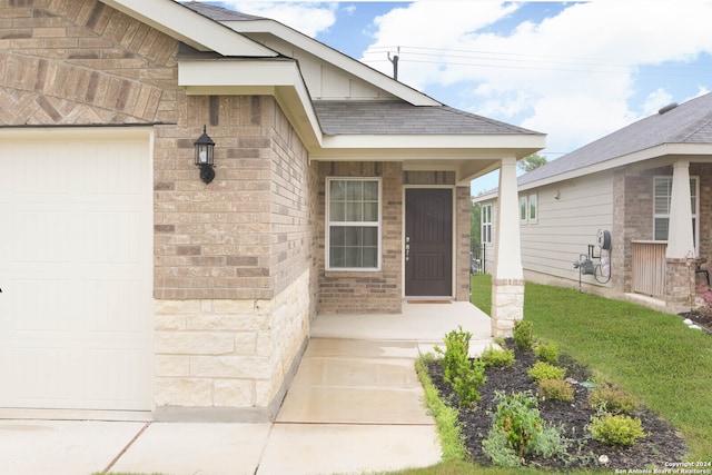 entrance to property with a porch and a garage