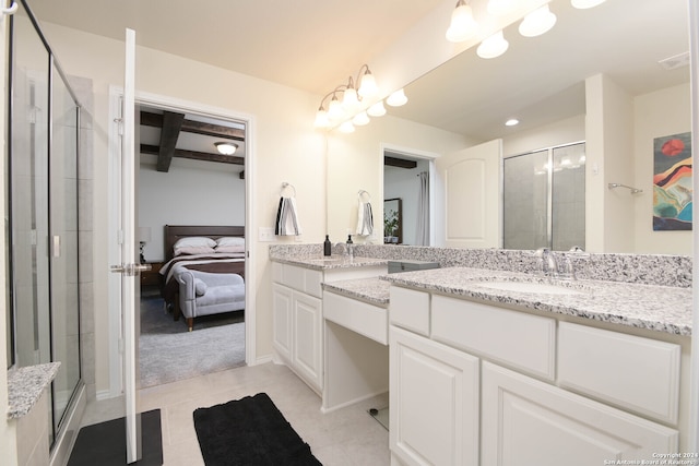 bathroom featuring vanity, tile patterned floors, and a shower with shower door