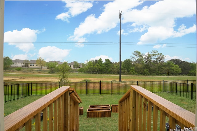 wooden terrace with a lawn