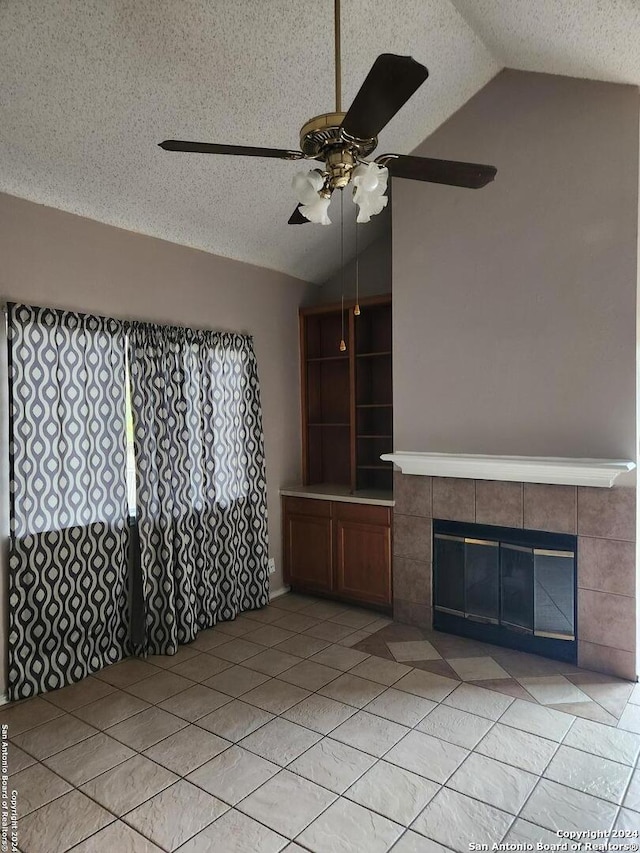 unfurnished living room featuring a fireplace, a textured ceiling, ceiling fan, and lofted ceiling