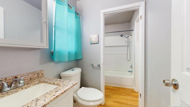 full bathroom with wood-type flooring, shower / bathing tub combination, vanity, and toilet