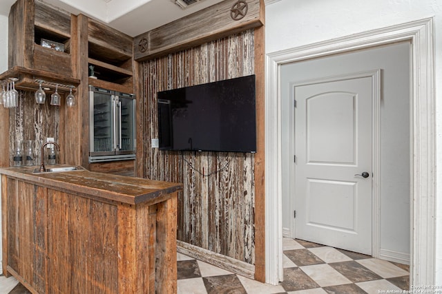 bar featuring beverage cooler and sink